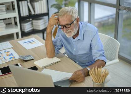 A caucasian senior Businessman working in modern office. Caucasian senior Businessman working in modern office