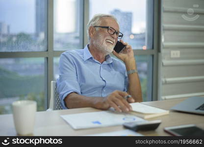 A caucasian senior Businessman working in modern office. Caucasian senior Businessman working in modern office