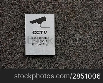 A cctv sign stating that there is cctv in the area