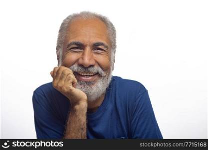 A CHEERFUL OLD MAN POSING IN FRONT OF CAMERA