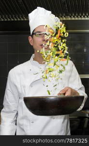 A chef and his sous-chef working in a kitchen