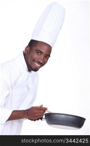 A chef holding a frying pan