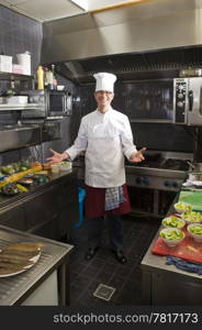 A chef in his kitchen, preparing dinner