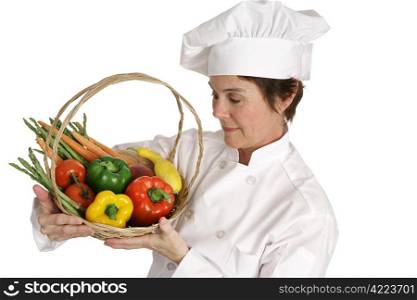 A chef inspecting a basket of fresh vegetables. Isolated on white.