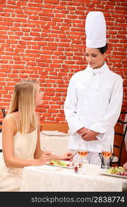 A chef talking with a patron