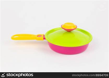 a children&rsquo;s toy plastic frying pan on a white background. children&rsquo;s toy plastic frying pan on a white background