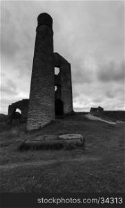 A chimney and some derelict buildings at a disused mine, Magpie Mine, in the Peak District