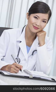 A Chinese Asian female medical doctor writing in a hospital office&#xA;