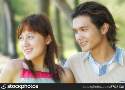 A chinese couple relax and flert together.