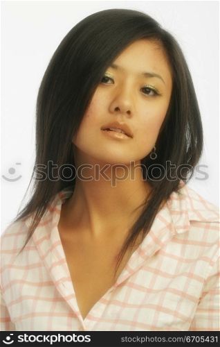 A chinese model poses in fashionable clothing in the studio.