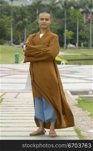A Chinese monk posing in traditional clothing.
