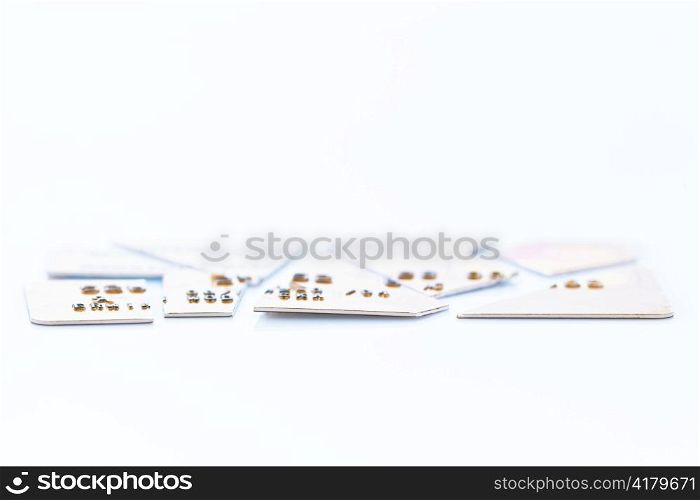 a chopped-up credit card lying on a white background. symbolic photo for debt.