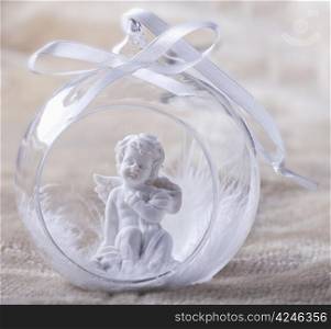 A Christmas bauble with little angel inside