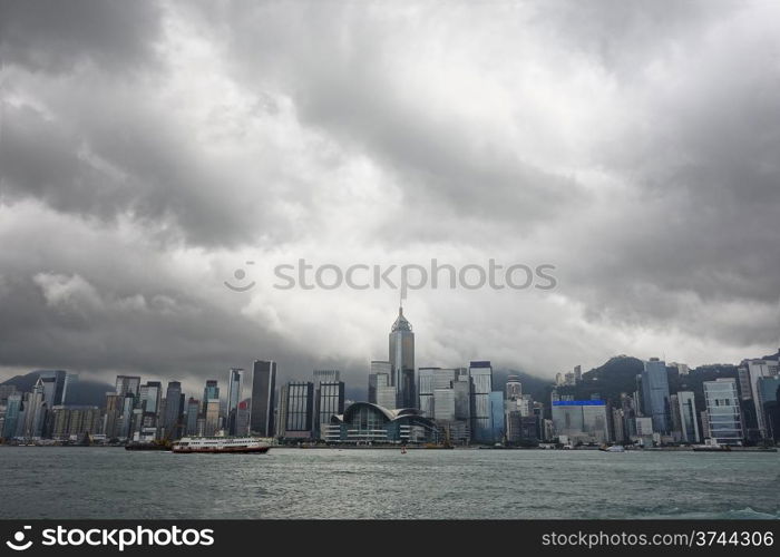 A cityscape of Hong Kong, including the convention center in Wan Chai, over Victoria Harbour from the Kowloon side.
