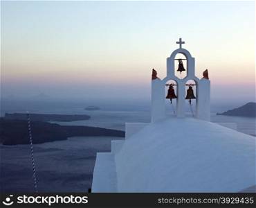 A clifftop Greek Orthodox Church high above the Mediterranean Sea on the volcanic island of Santorini.