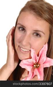 A close-up head shot of a beautiful woman, holding a silk pink lily smilinginto the camera, for white background.