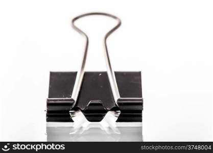 A close up image of a binder clip on a white background