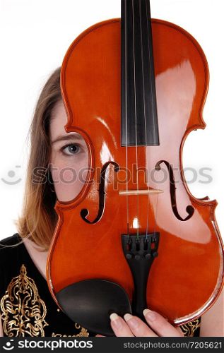 A close up image of a violin and a woman hiding behind just looking with one eye, isolated for white background
