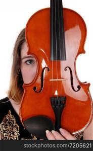A close up image of a violin and a woman hiding behind just looking with one eye, isolated for white background