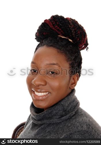 A close up image of an African American woman with her curly hair as a bun on her head, smiling, isolated for white background