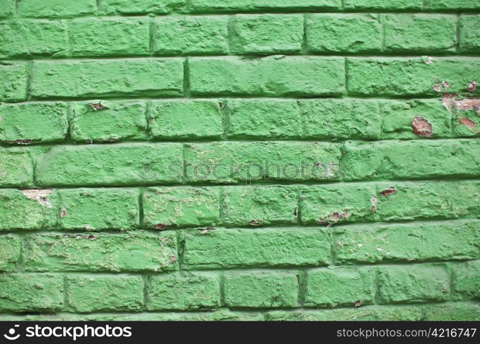 a close-up of an old aged green colored brickwall