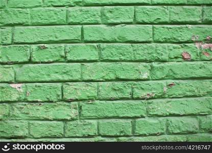 a close-up of an old aged green colored brickwall