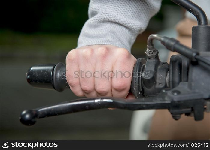 a close up of hand on handlebar