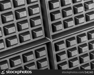 A close up shot of a waffle iron selectiv focus