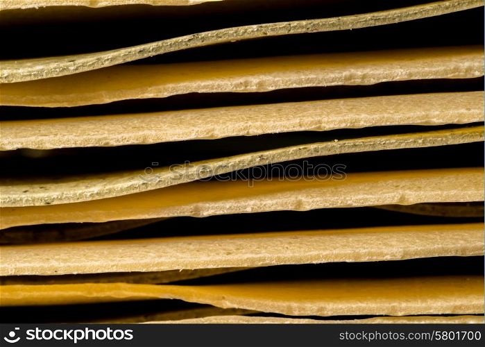 A close up view of stacked pieces of lasagna pasta.