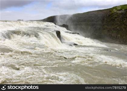 A close up view on one of Iceland&rsquo;s most impressive water falls, the Dettifoss. 193 cubic meters of water hurdles down through the 44m high, and 100m wide waterfall