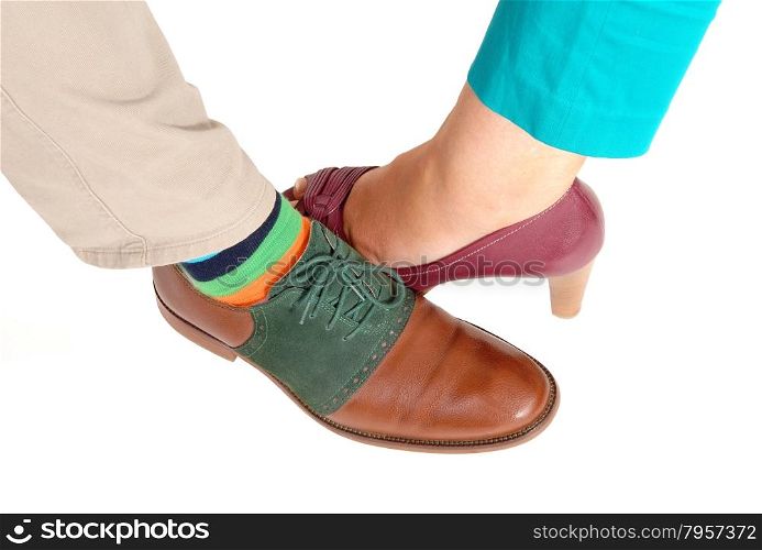 A closeup few of the shoe of a woman and man standing isolated onwhite background.