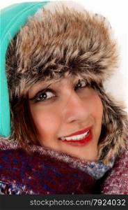 A closeup head shoot of a young woman with a big scarf around her neck and head, dressed for very cold weather.