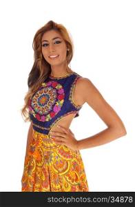 A closeup image of a beautiful young woman in a gorgeous dressstanding with her hands on her hips, isolated for white background.