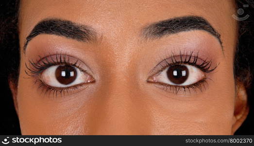 A closeup image of the big eye&rsquo;s of an African American woman.