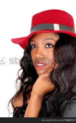 A closeup of a African American woman in a black blouse and long black curly hair with a red hat, isolated for white background.