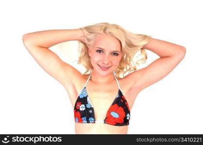 A closeup of a pretty bikini girl with long blond hair, standing in the studio for white background.