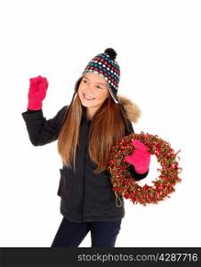 A closeup picture of a eight year old girl, smiling and holding a colorfuladvents wreath, isolated for white background.