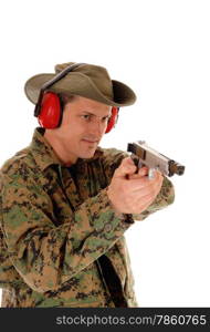 A closeup picture of a soldier in a camouflage uniform pointing a pistol,with ear protection, isolated on white background.