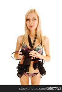 A closeup picture of an photographer woman in a bikini standing for whitebackground isolated with three cameras in the studio.