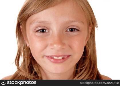 A closeup picture of the face of a eight year old girl, smiling, isolatedfor white background.