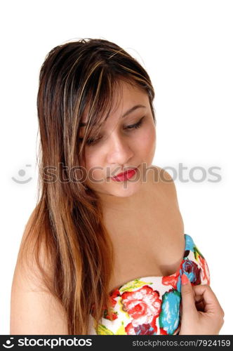 A closeup picture of the face of a serious young woman with her handon her chest, isolated for white background.