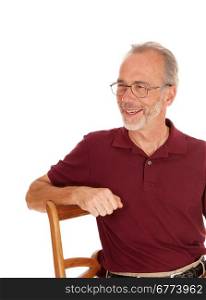 A closeup portrait image of a middle age man, smiling, sitting on a chair,isolated for white background.