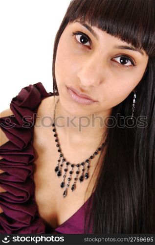 A closeup portrait of a gorgeous woman in a burgundy dress and longblack hair and a necklace, looking strait into the camera, over white.