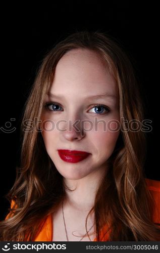 A closeup portrait picture of a lovely teenage girl with blue eye&rsquo;s, isolated for black background.
