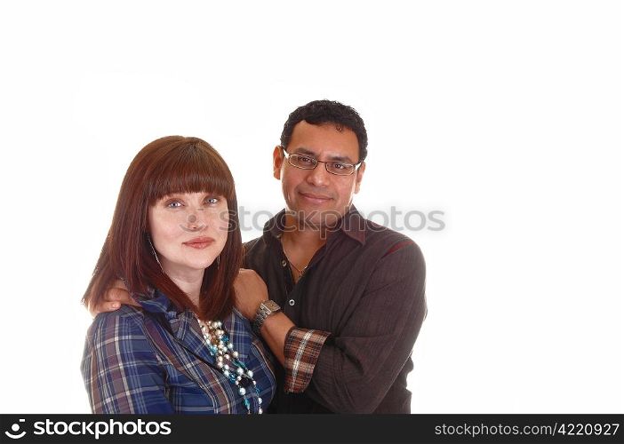 A closeup shoot of a mixed couple, Hispanic and Caucasian, she withred hair, blue shirt and necklace, standing for white background.