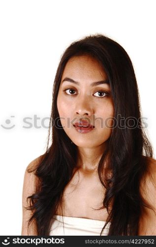 A closeup shoot of a pretty Asian girl with long black hair, lookinginto the camera for white background.