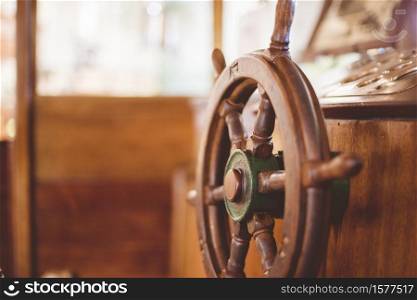 A closeup shot of a boat steering wheel with a blurred background. Closeup shot of a boat steering wheel with a blurred background