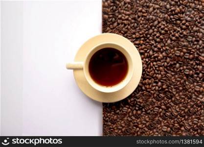 A closeup shot of a cup of coffee with coffee beans on a white background