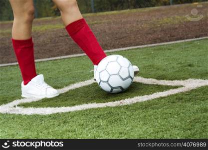 A closeup shot of a female soccer player taking a corner kick