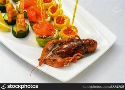 A closeup shot of cooked cancer with appetizers on skewers on the plate. Closeup shot of cooked cancer with appetizers on skewers on the plate